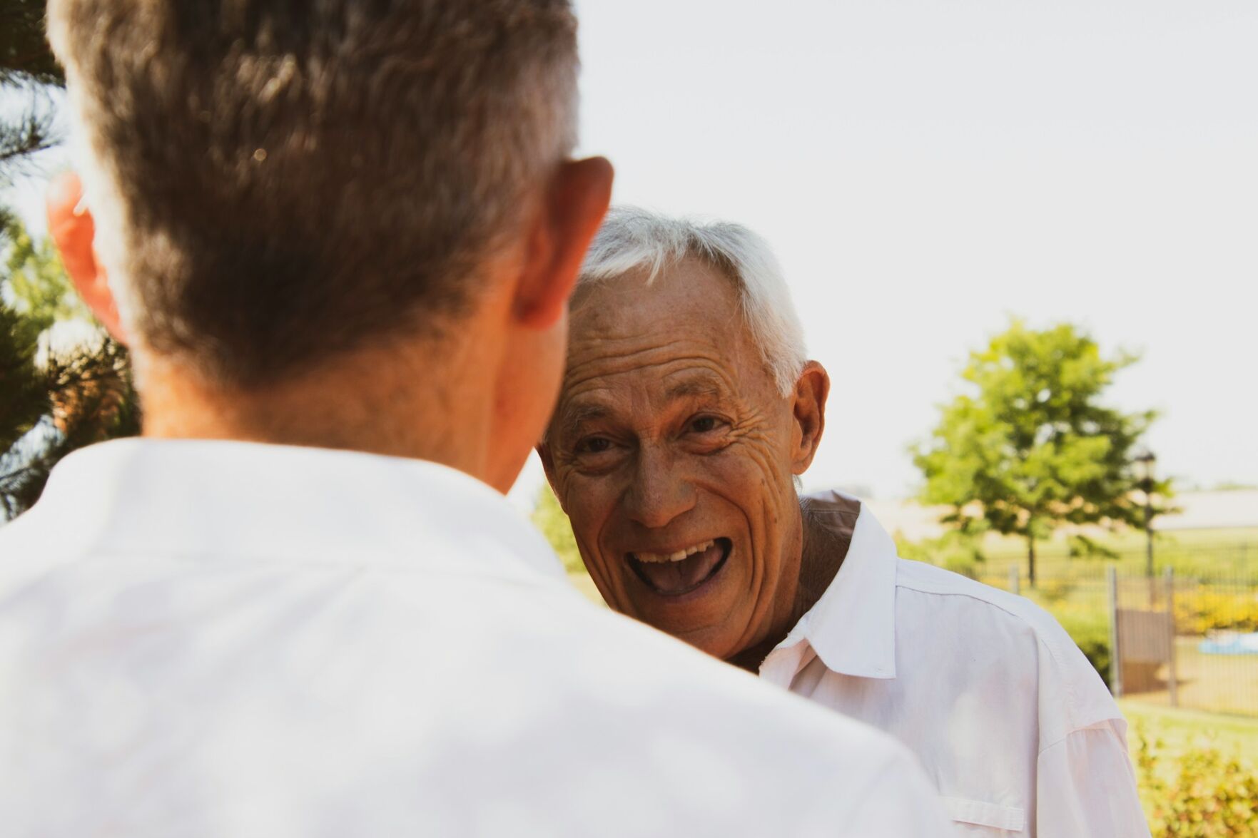 Elderly man grins at his friend